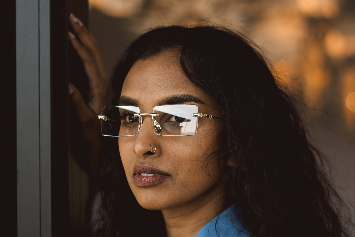 Crystal rimless sunglasses worn